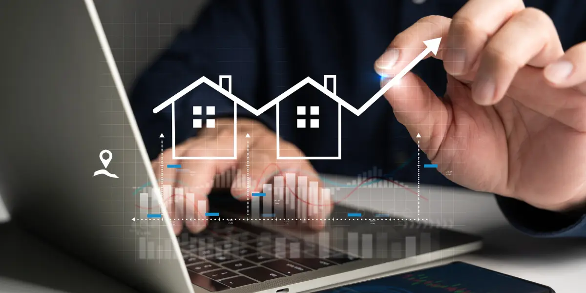 Gestão de leads imobiliários: A cena é composta de um close-up que foca nas mãos de uma pessoa digitando em um laptop, com sobreposições gráficas que incluem casas estilizadas, barras e um gráfico de seta ascendente.
